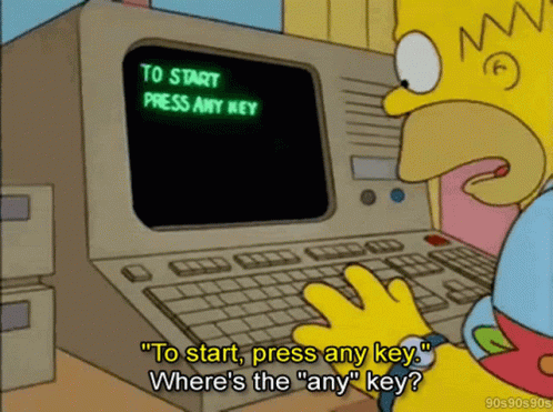 The screen prompts Homer to press any key to start. He looks for a key called any.